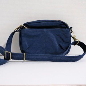 Travelon Anti theft Crossbody with Locking Zippers- Blue. Dimensions are 7x9x2